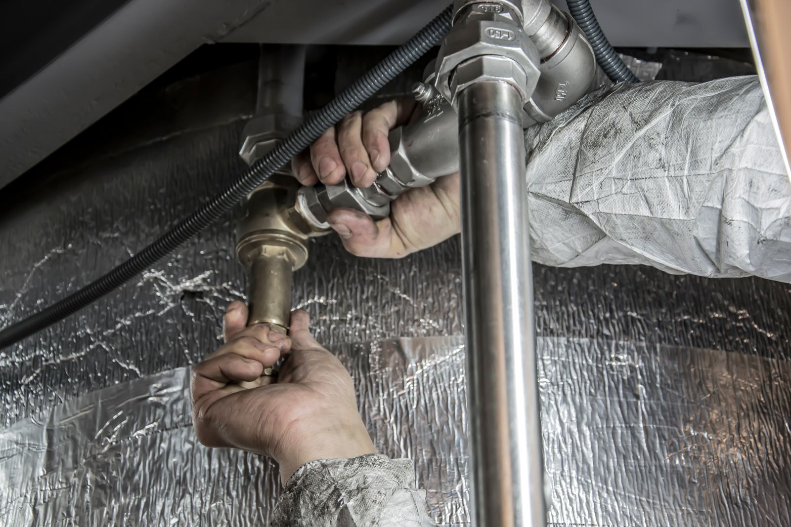 Close-up of copper pipework being repaired by a licensed plumber