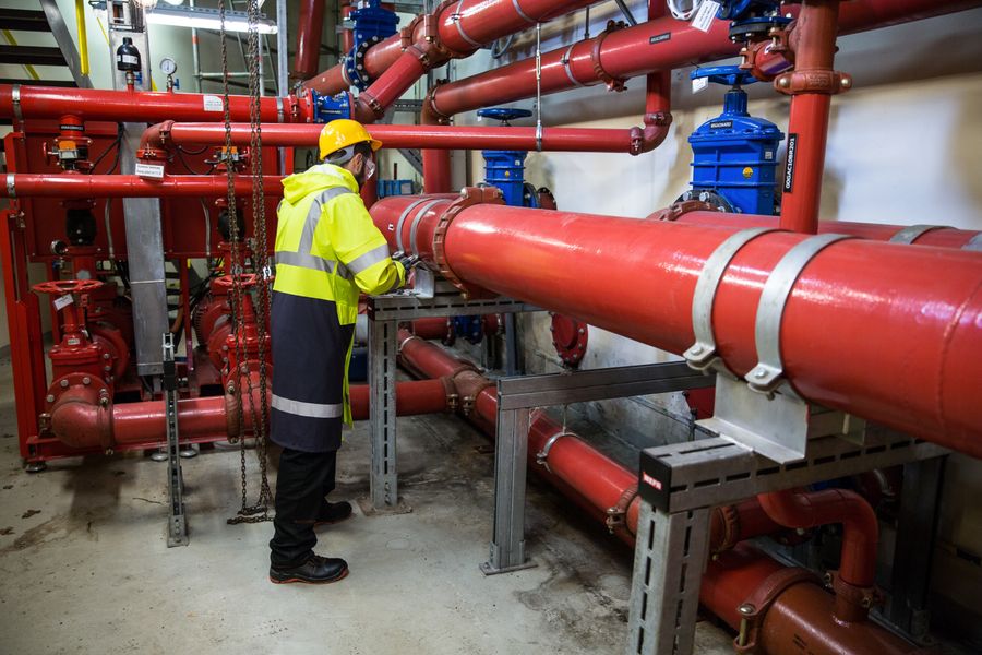Pressure-testing red pipework during an inspection